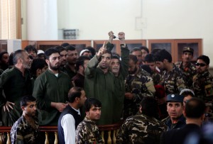 Defendants speak during their trial at the Primary Court in Kabul, Afghanistan, Sunday, May 3, 2015. The trial of 49 suspects, including 19 police officers, on charges relating to the mob killing of an Afghan woman began in the capital, Kabul, on Saturday. The opening of the trial at Afghanistan's Primary Court was broadcast live on nationwide television. The suspects all face charges relating to the March 19 killing of a 27-year-old woman named Farkhunda. (AP Photo/Rahmat Gul)